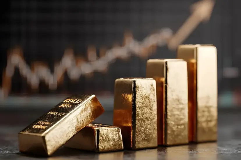 شمش‌های طلای براق در کنار نمودار صعودی قیمت طلا