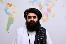مردی با پوشش سنتی طالبان در مقابل نقشه جهان
