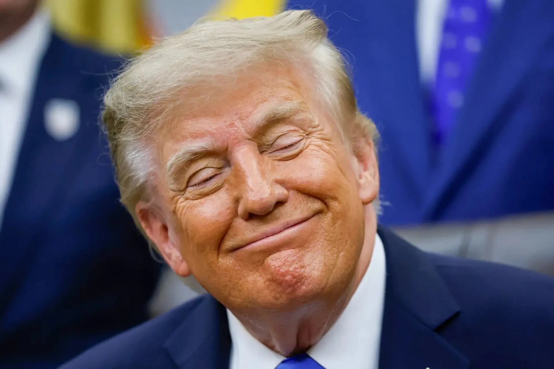 دونالد ترامپ (Donald Trump) با چشم‌های بسته و لبخند در یک مراسم رسمی