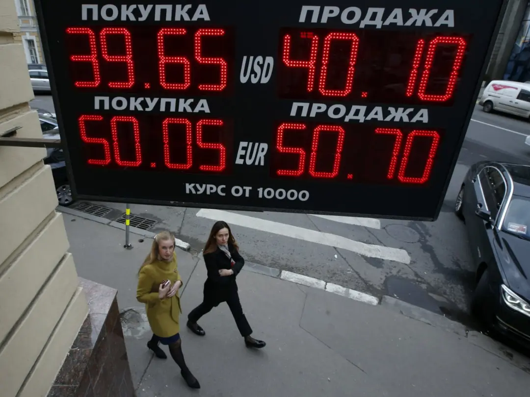 تابلو دیجیتال نرخ ارز روبل (Rouble) در مقابل دو زن در خیابان