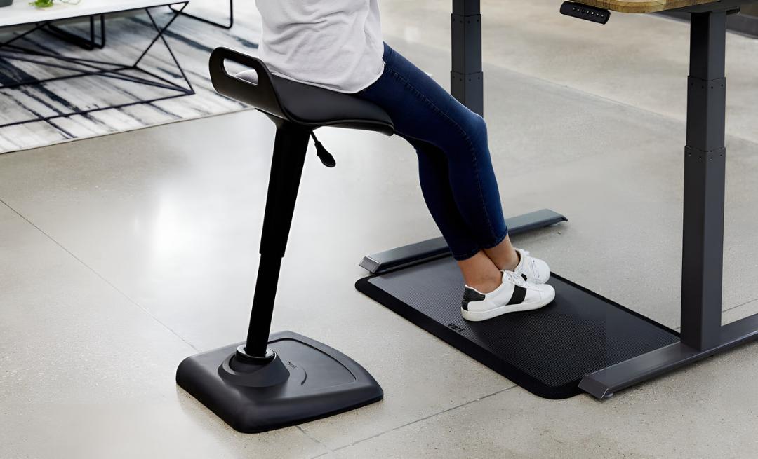 صندلی ایستاده (Perch Stool) در کنار میز کار ایستاده و مت پد