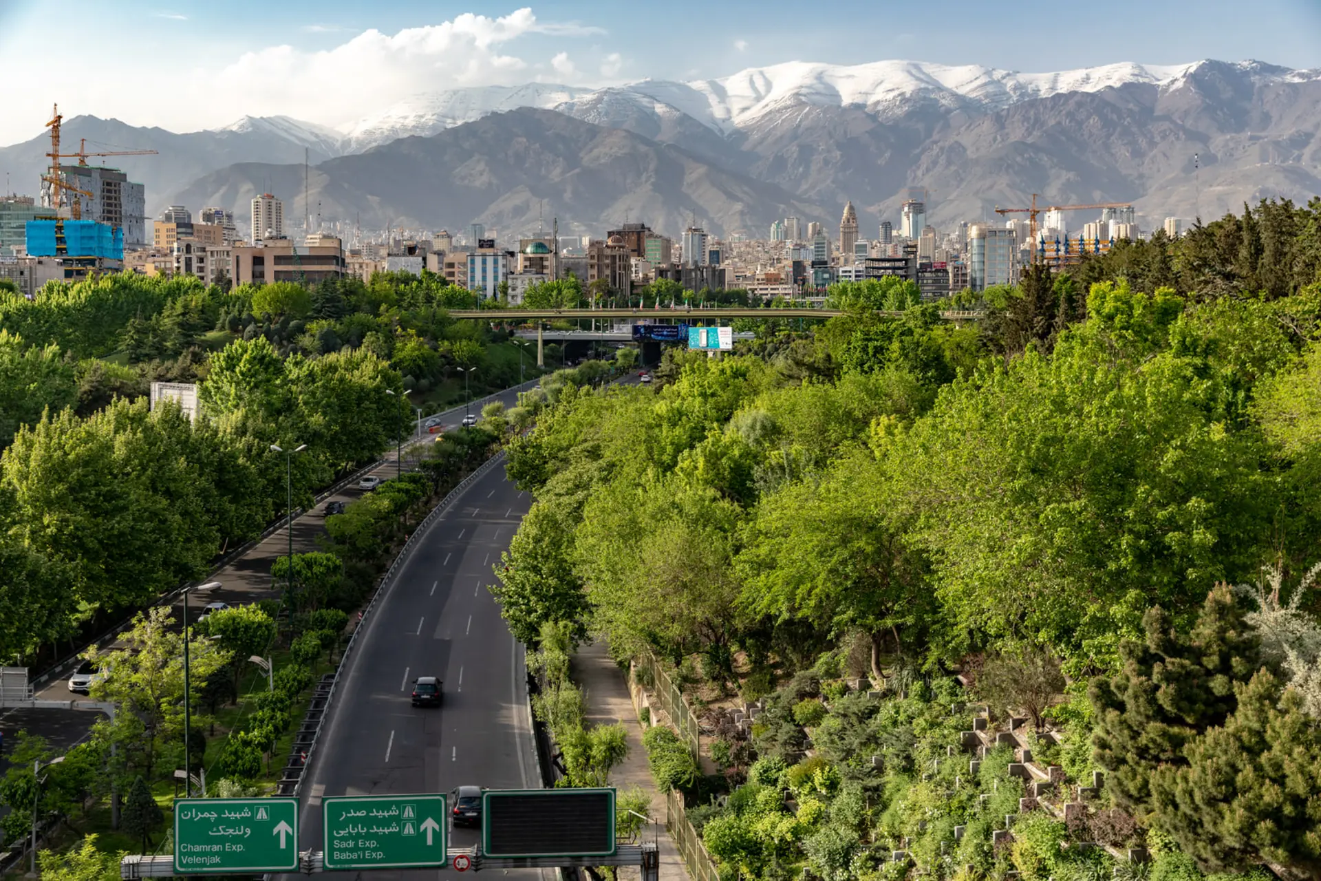 نمای شهر تهران (Tehran) با کوه‌های پوشیده از برف در پس‌زمینه