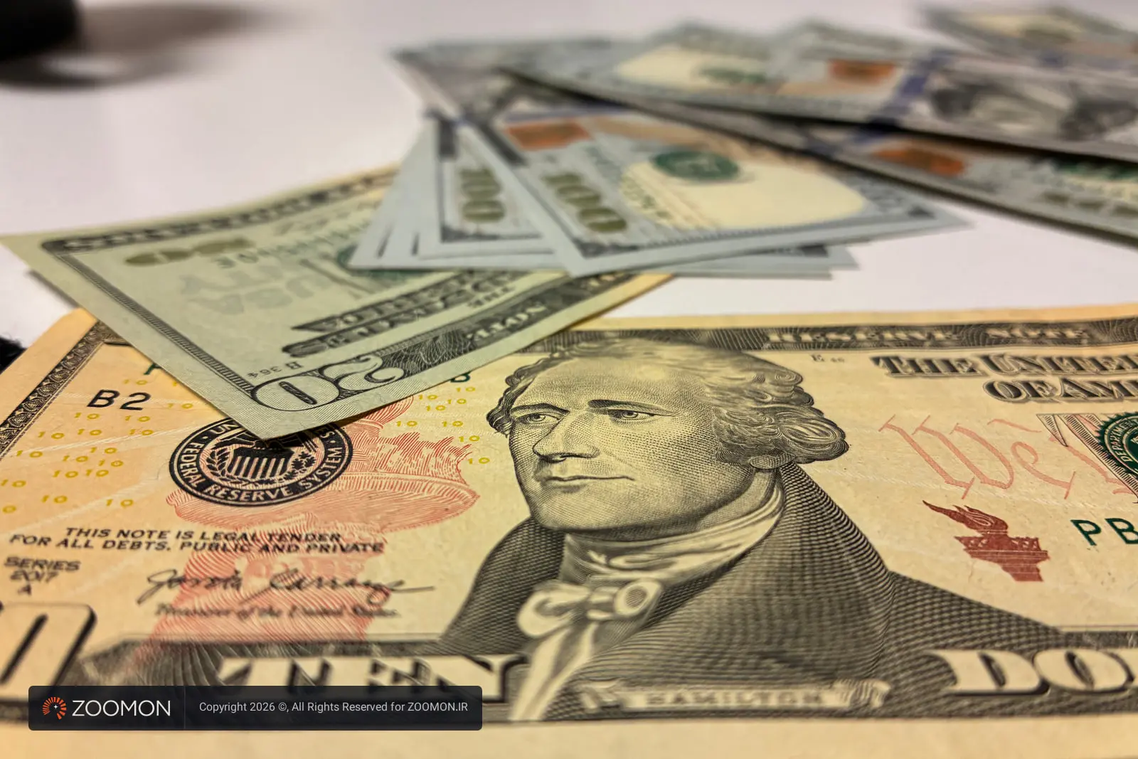 اسکناس‌های دلار آمریکا (US Dollar) روی یک سطح سفید
